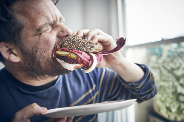 Tom Hunt eating a veggie burger